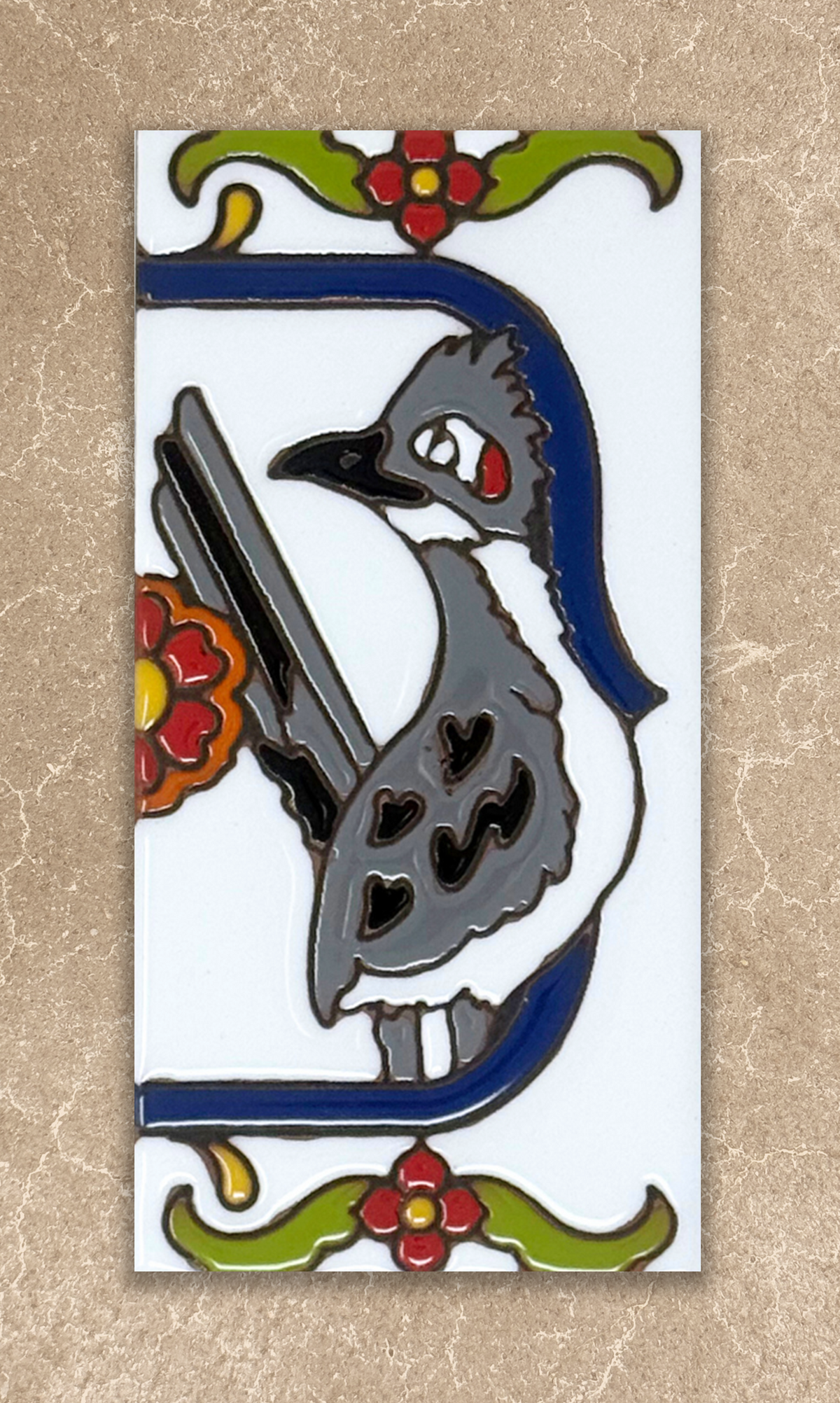 Decorative tile with a stylized bird design on a beige background