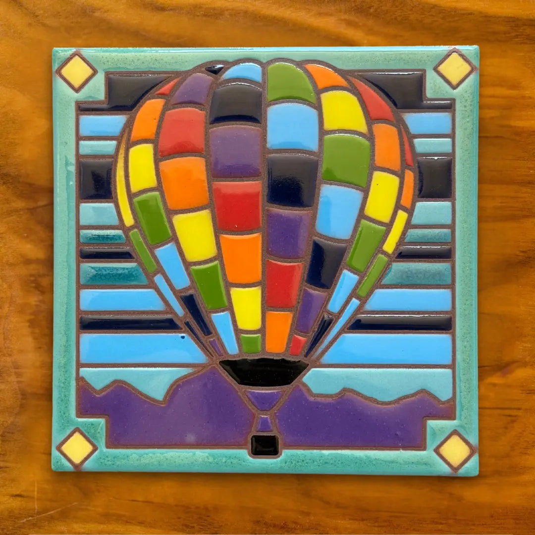 Colorful mosaic hot air balloon on a wooden surface