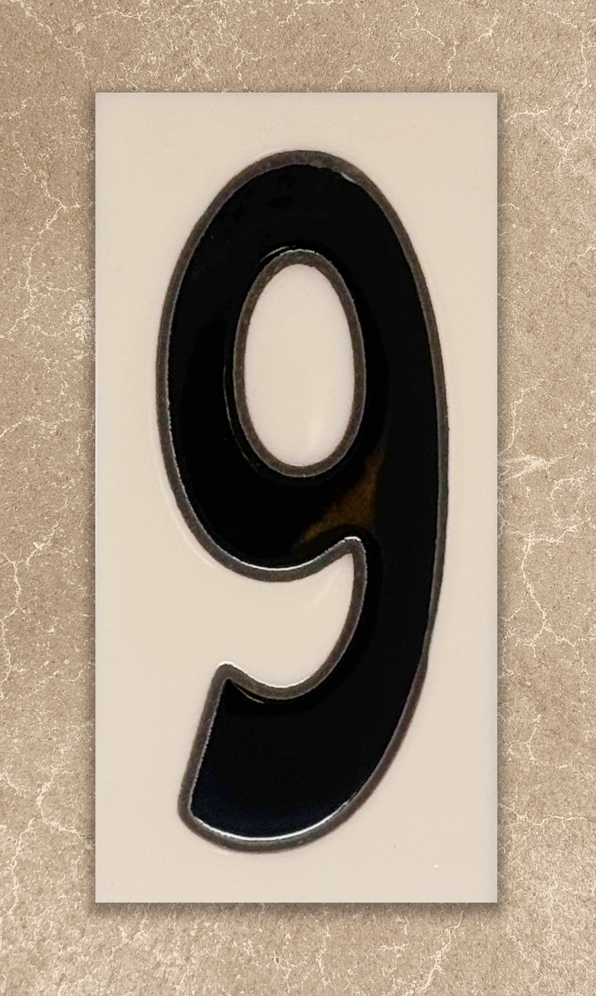 Black number '9' on a beige background