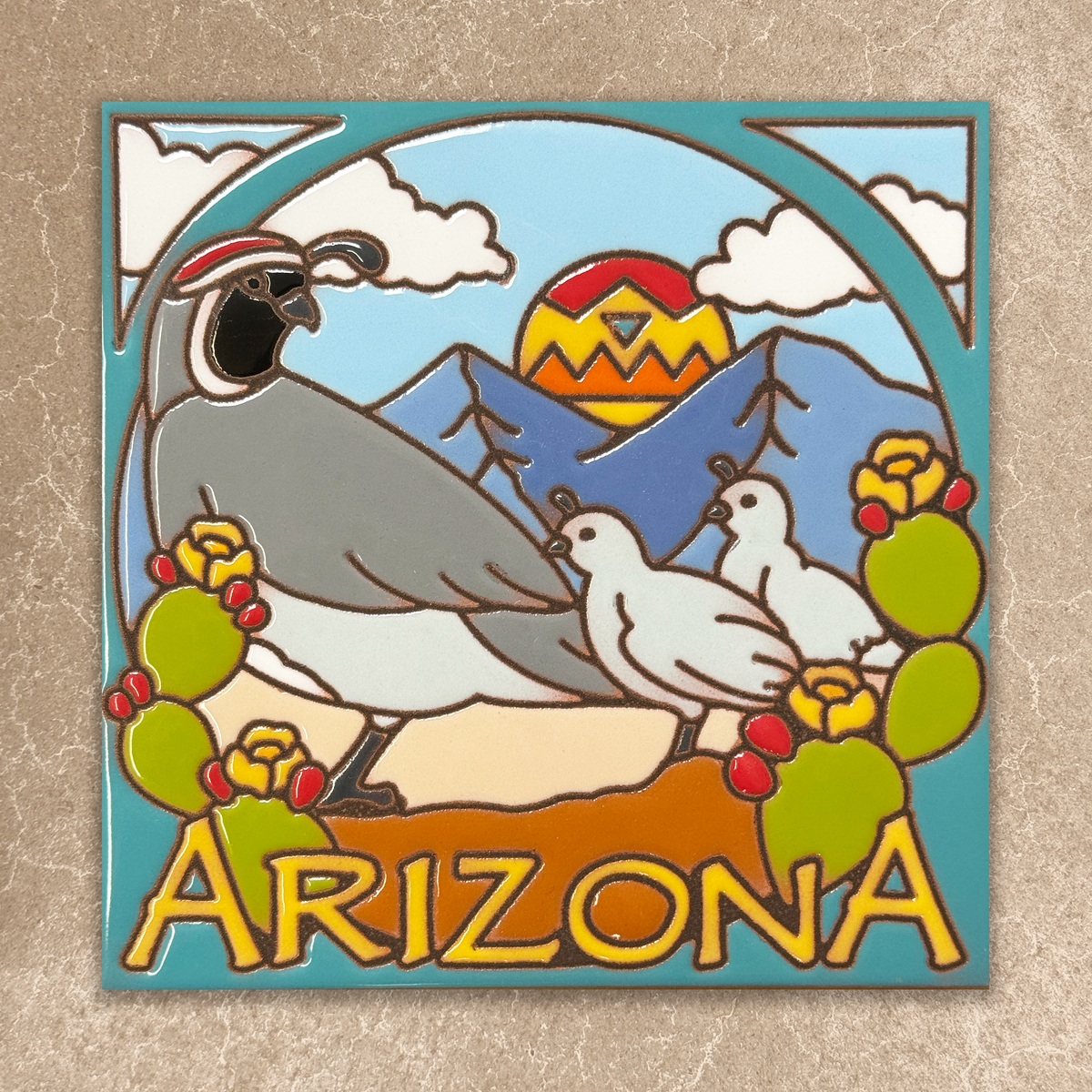 Decorative tile with desert scene featuring a mountain, sunset, and desert animals on a beige background.