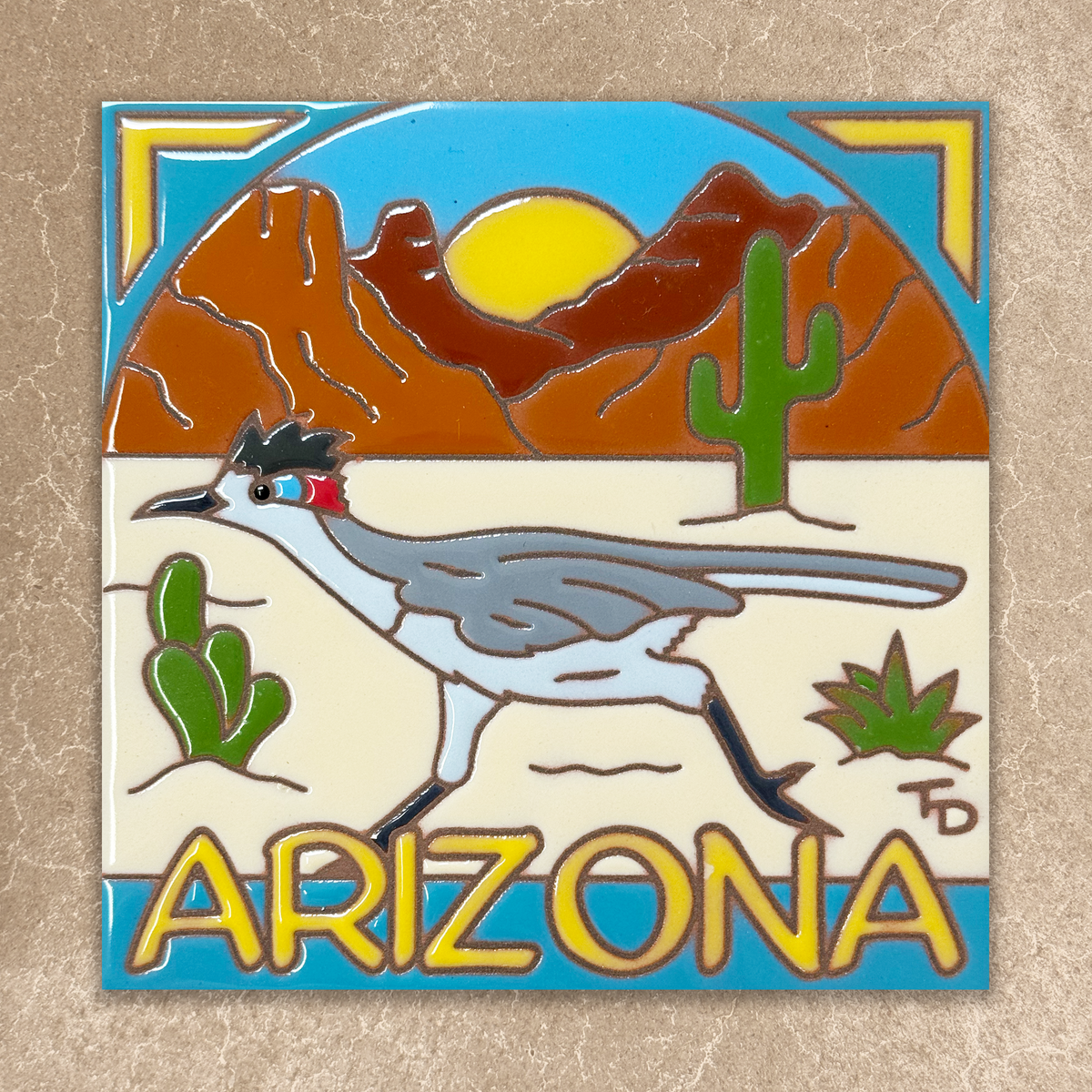 ceramic tile with roadrunner and arizona text in yellow