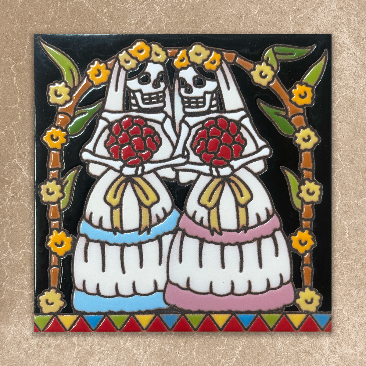 Decorative tile with two skeletons holding flowers, framed by floral elements on a beige background