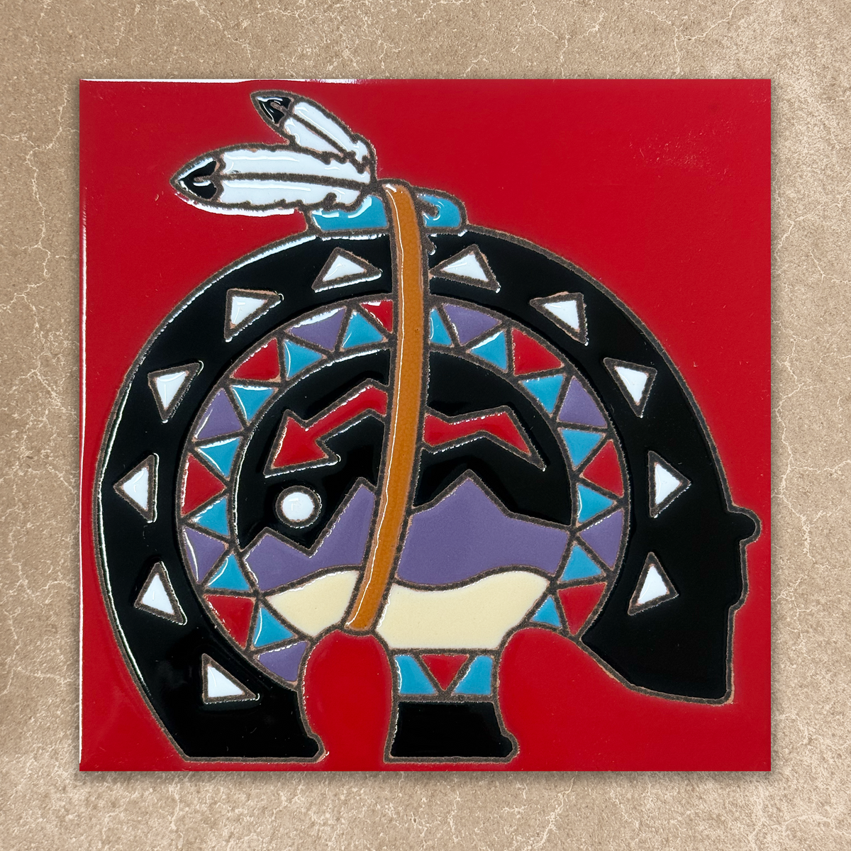 Decorative tile with geometric design on a red background