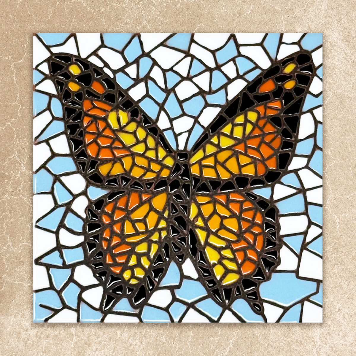 Mosaic butterfly art piece on a beige background