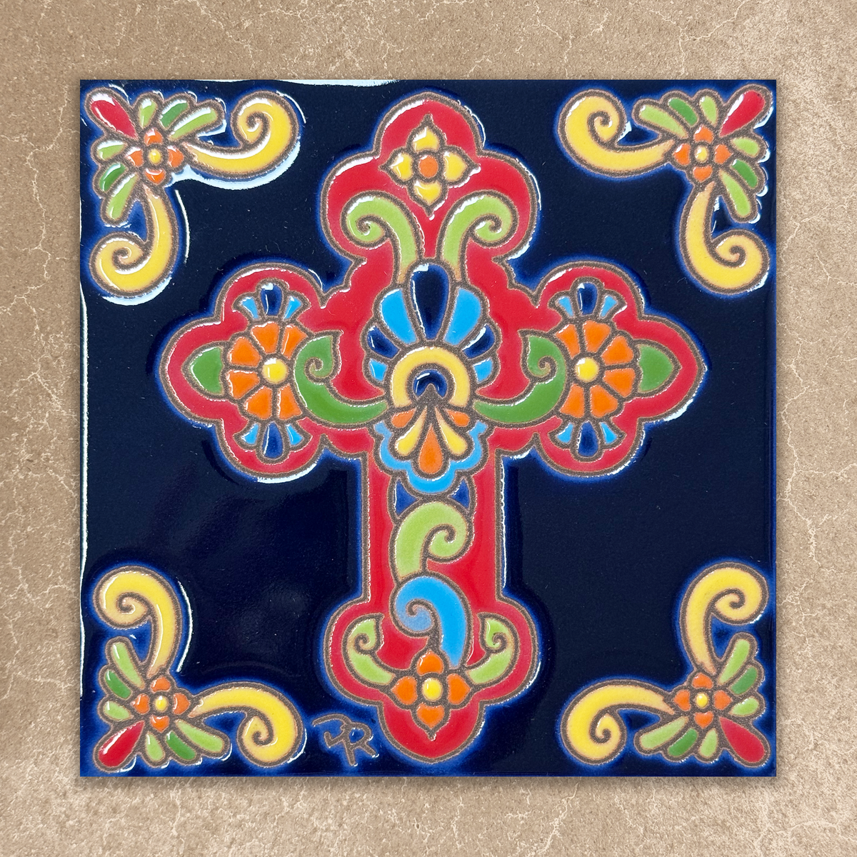 Decorative tile with a colorful cross design on a blue background
