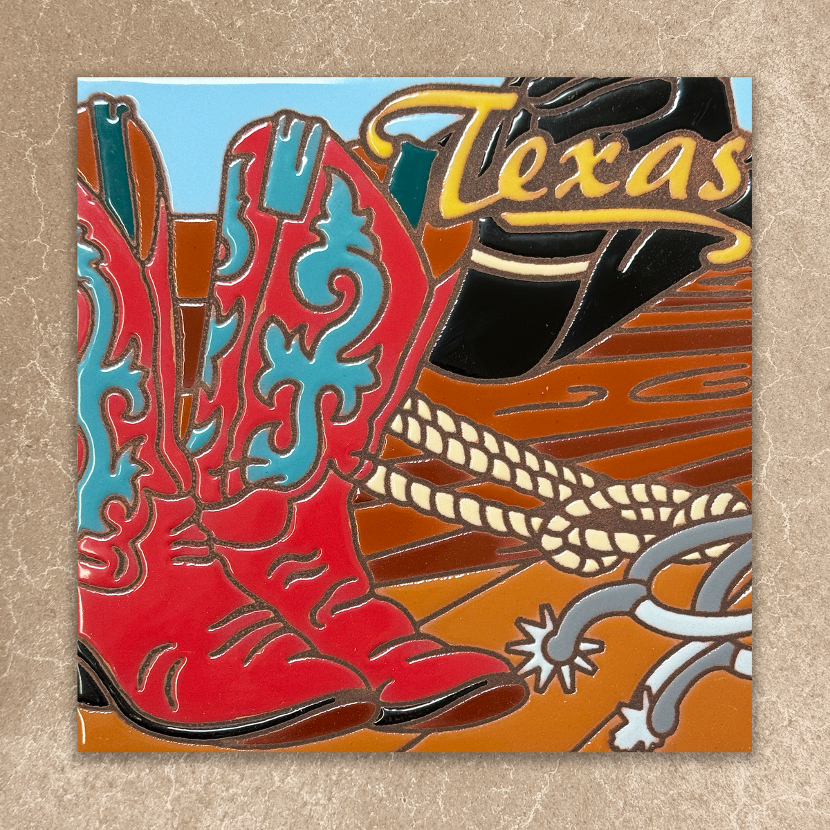 Colorful ceramic tile of a cowboy boot with 'Texas' text on a textured background