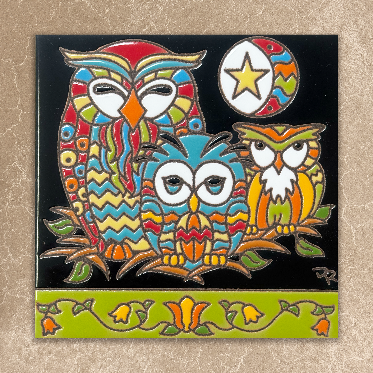 Colorful owl design on a black background with a decorative green border.