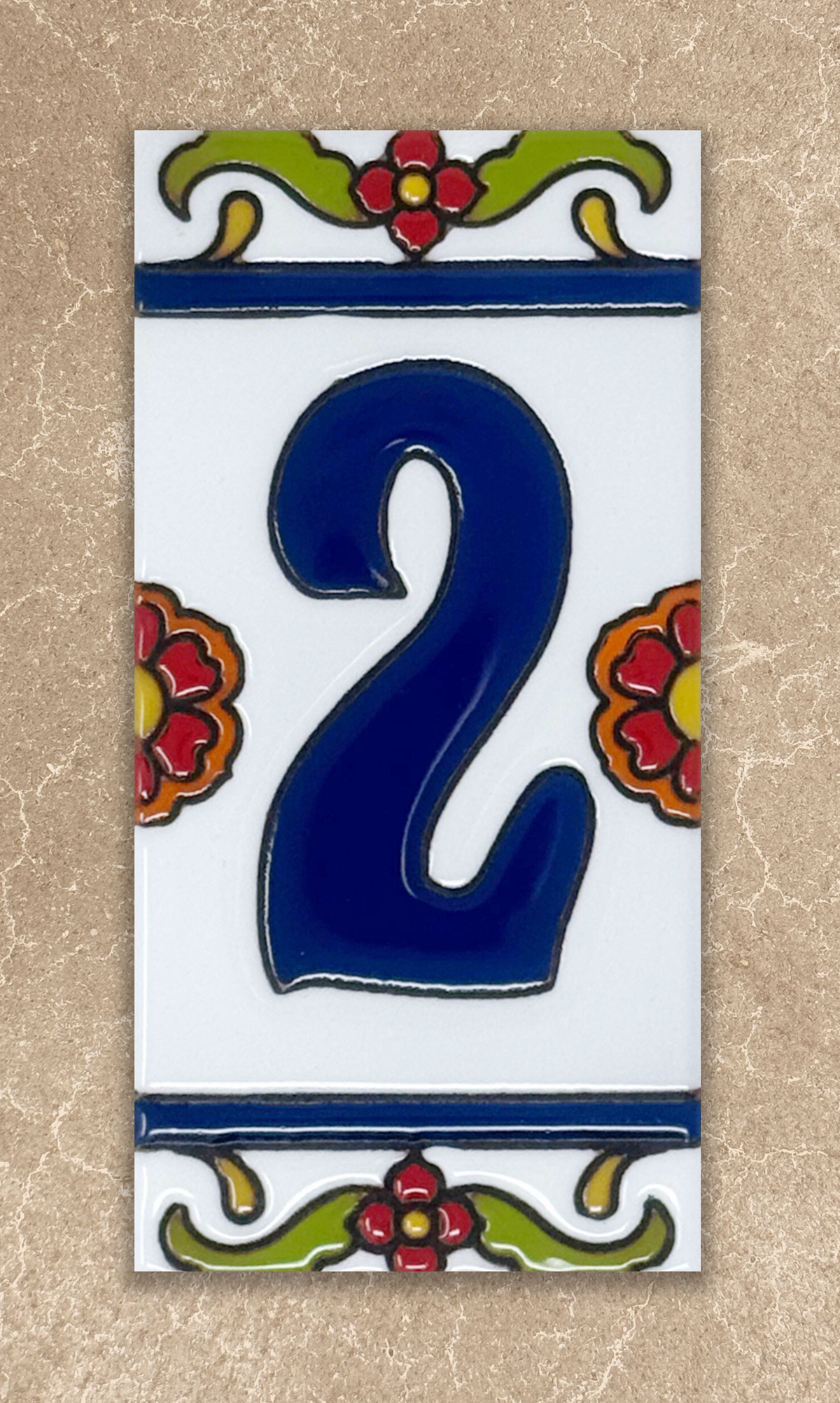 Decorative tile with the number '2' in blue, surrounded by floral designs on a beige background