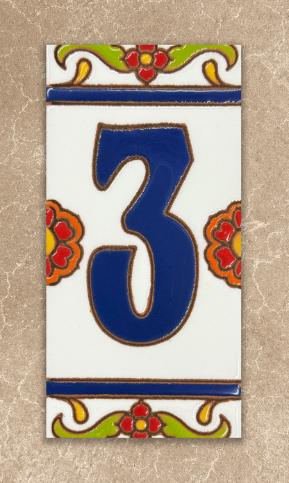 Decorative tile with the number '3' in blue, surrounded by floral designs on a beige background