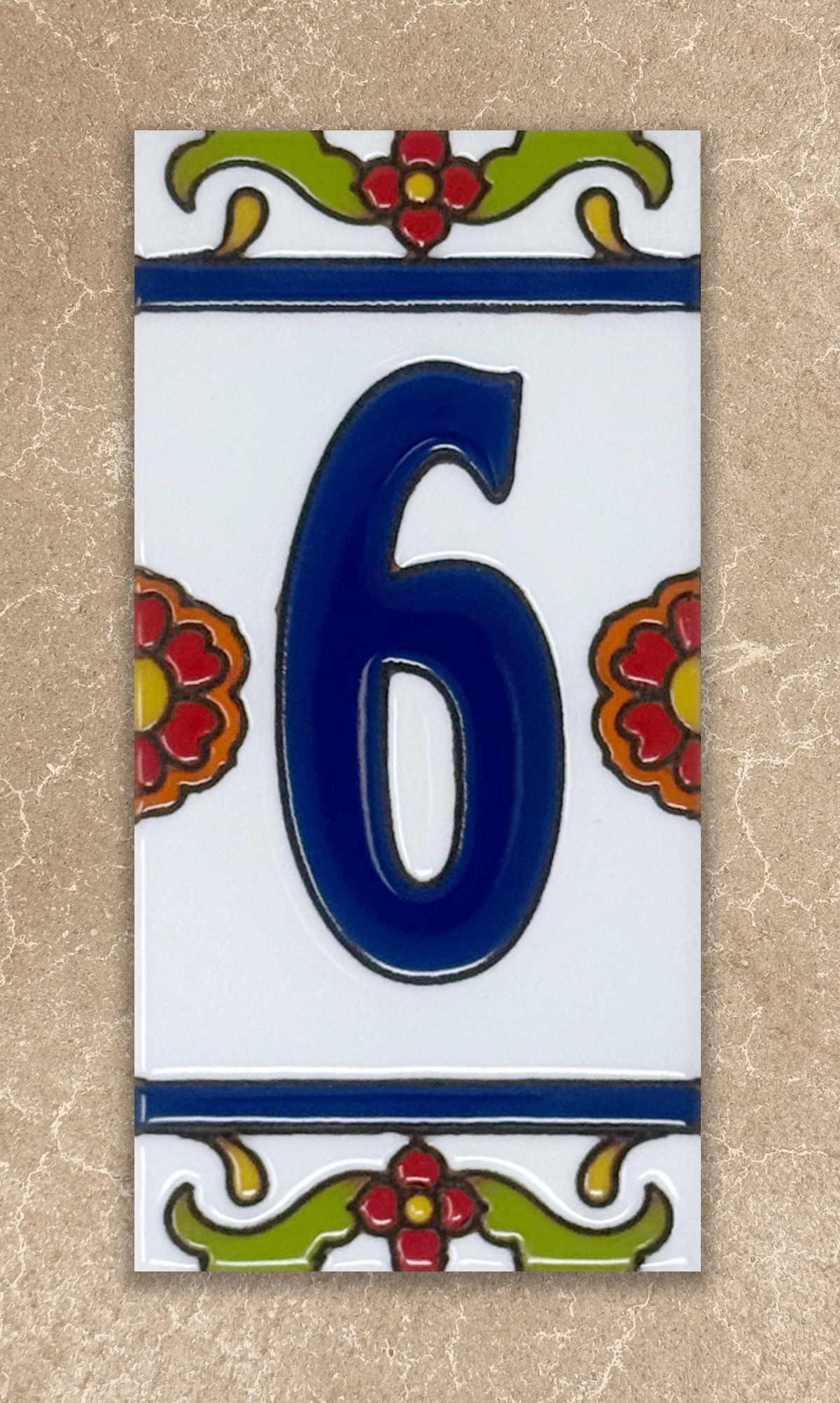 Decorative house number '6' on a ceramic tile with floral designs on a beige background