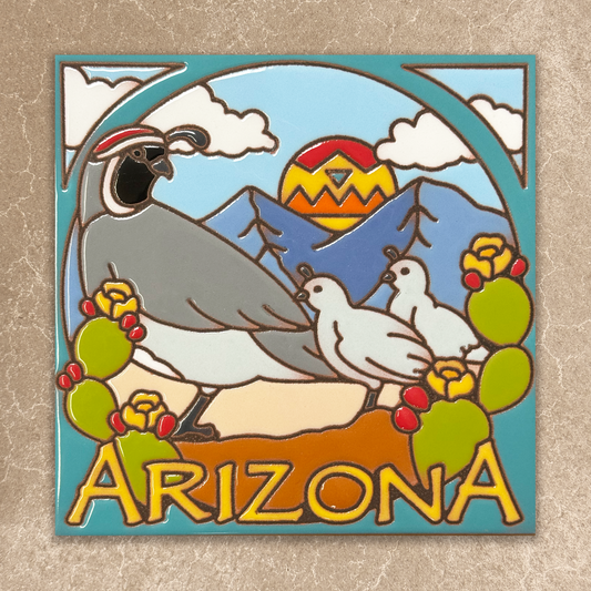 Decorative tile with desert scene featuring a mountain, sunset, and desert animals on a beige background.