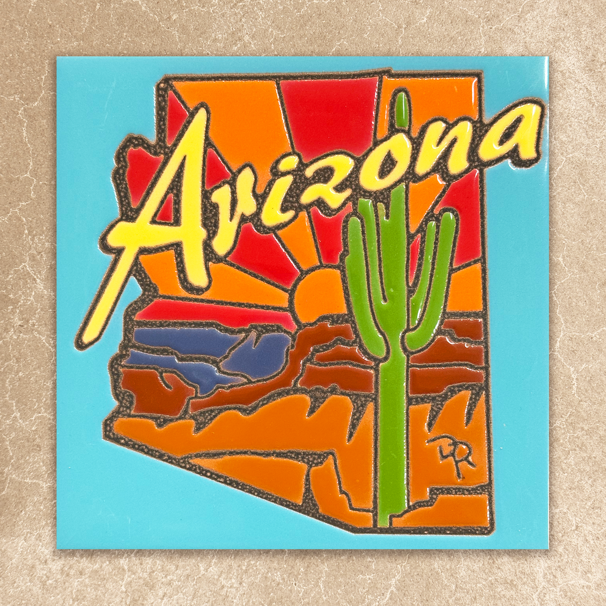 ceramic tile of desert landscape on a blue background, yellow arizona text