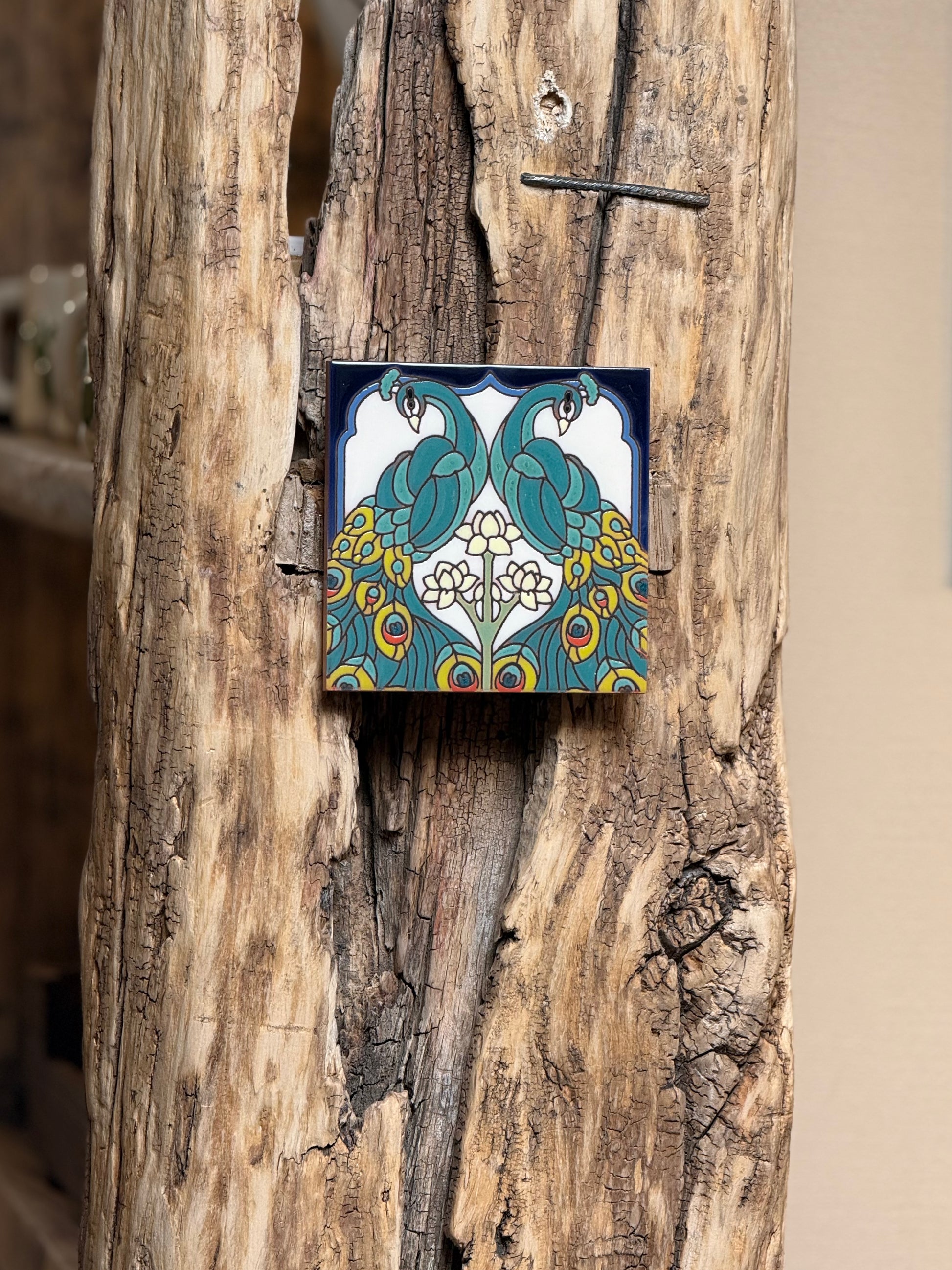 Decorative tile with a colorful design on a wooden surface