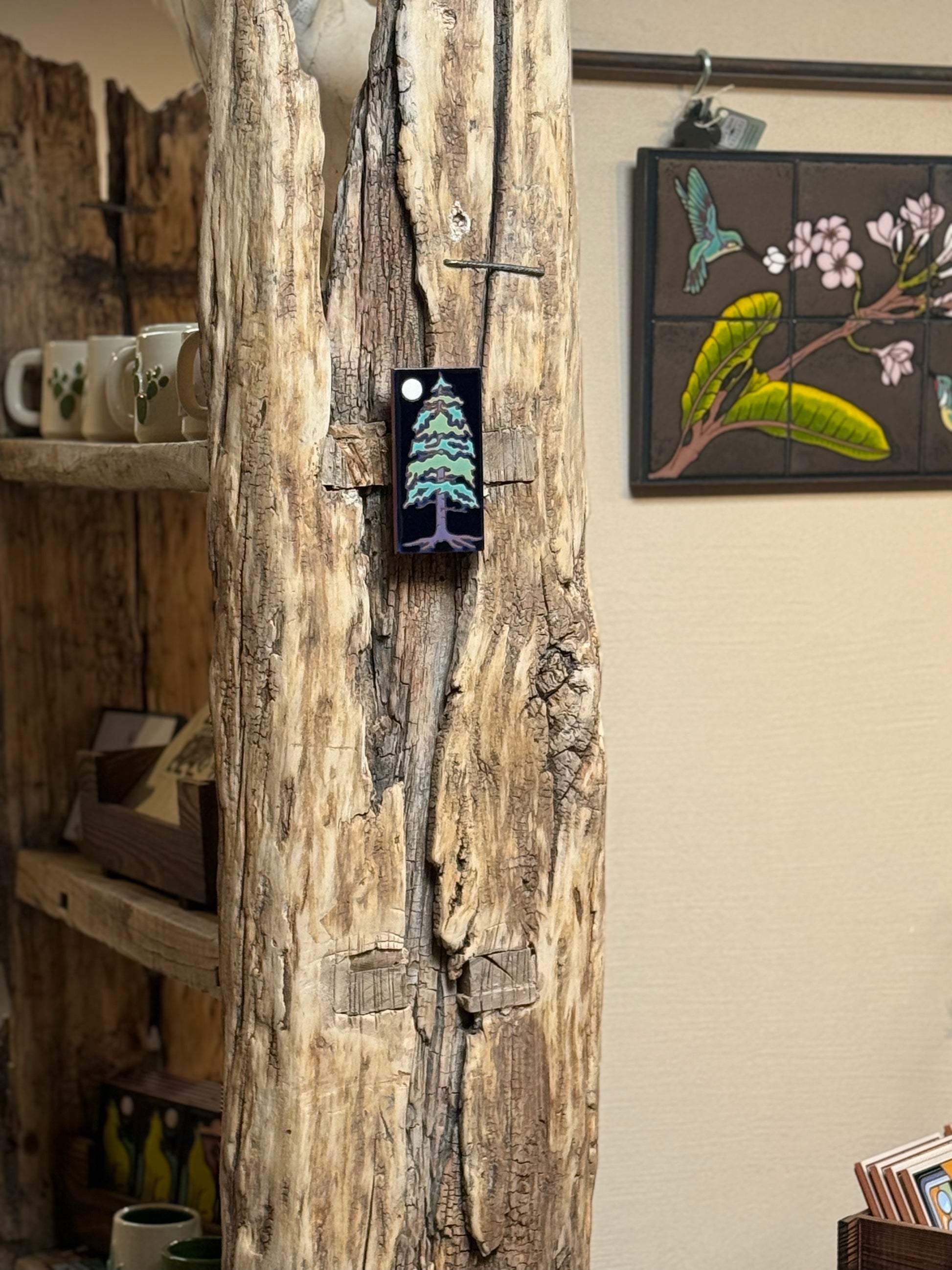 Wooden wall art with a tree design in a rustic setting