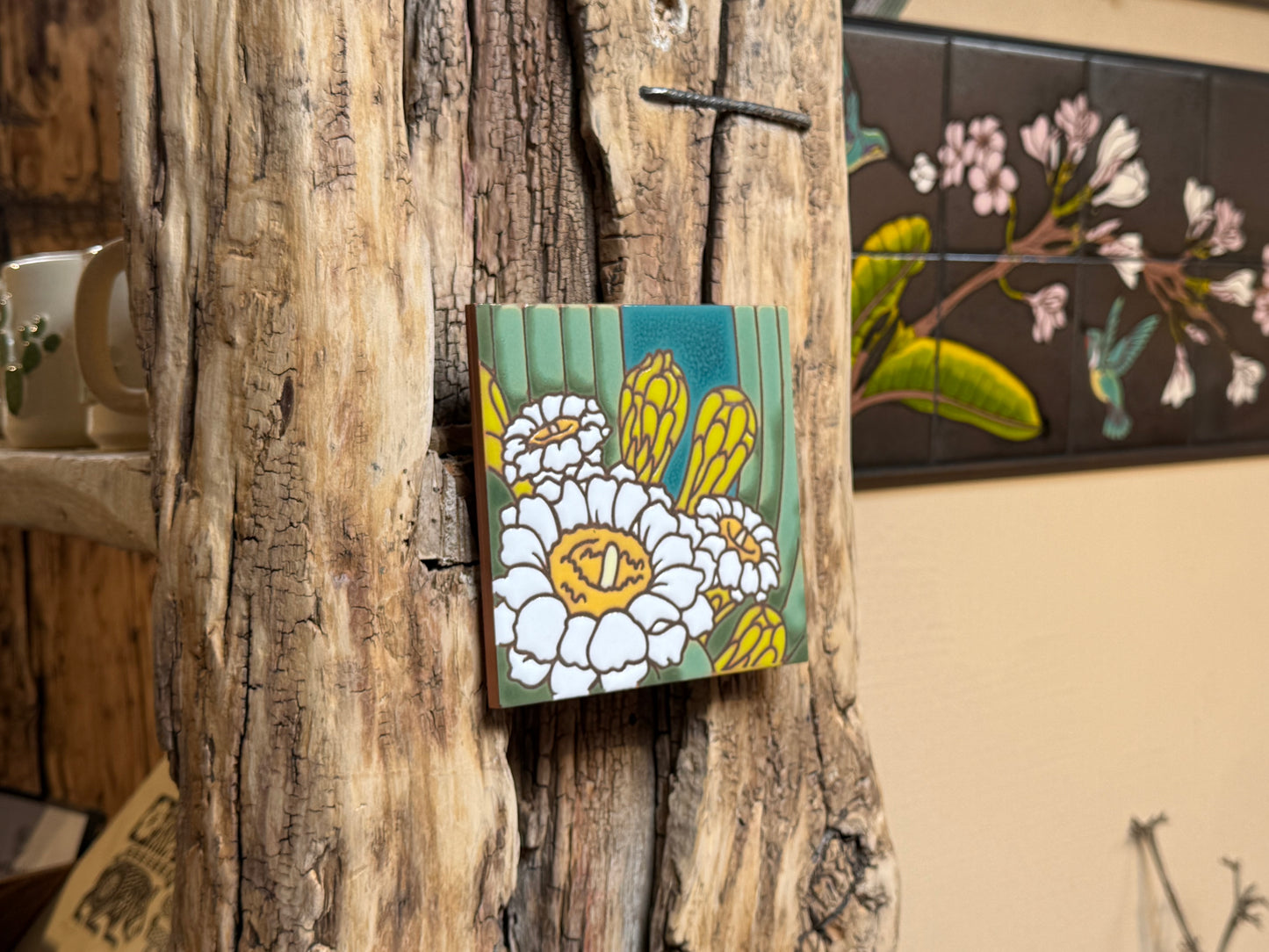 Floral tile on a wooden surface with a rustic background