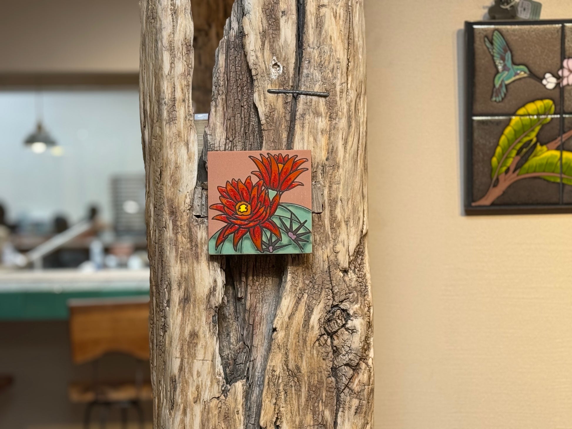 Small floral painting on a wooden surface with a blurred background