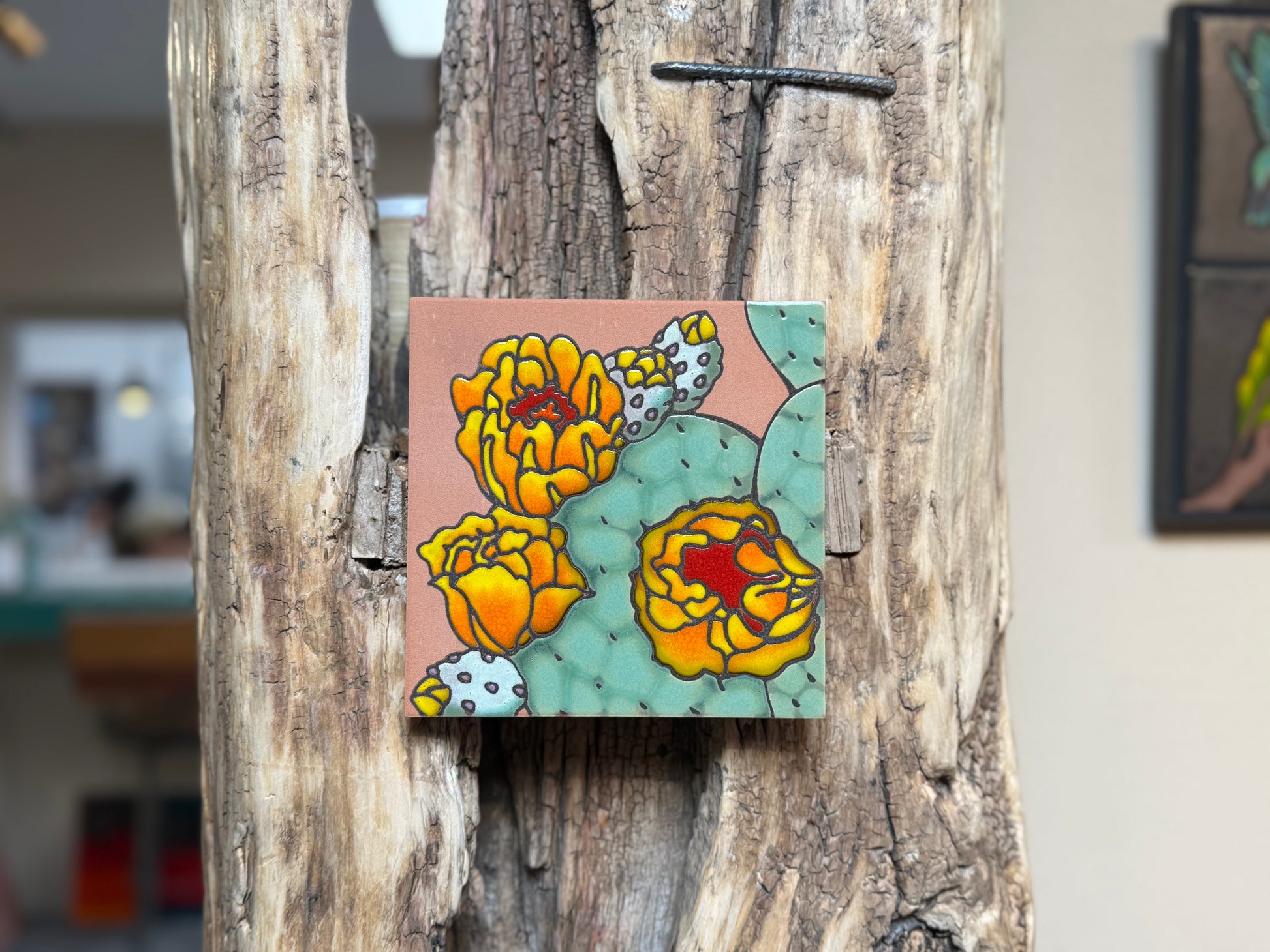 Colorful floral tile attached to a wooden surface