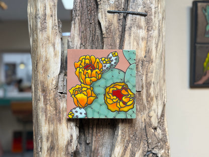 Colorful floral tile attached to a wooden surface