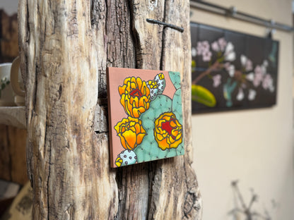 Colorful floral painting on a wooden surface with a blurred background