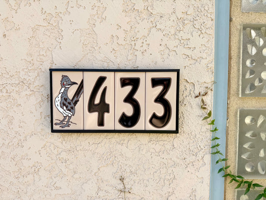 black numbers on beige tile house sign
