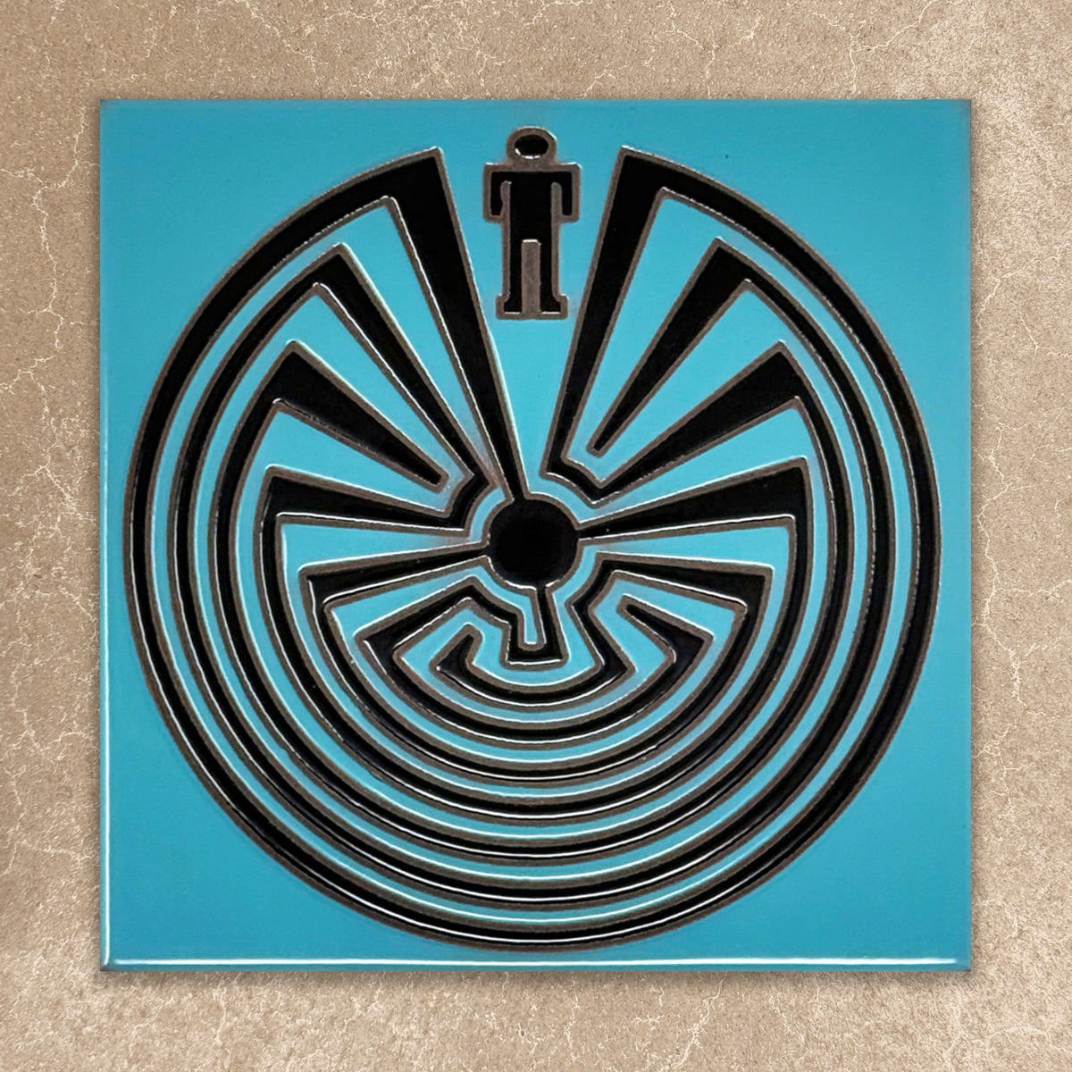 Black labyrinth design on a blue square background
