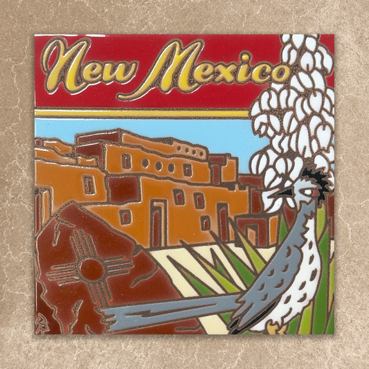 Enamel pin with New Mexico design featuring a building, cactus, and roadrunner on a red background.
