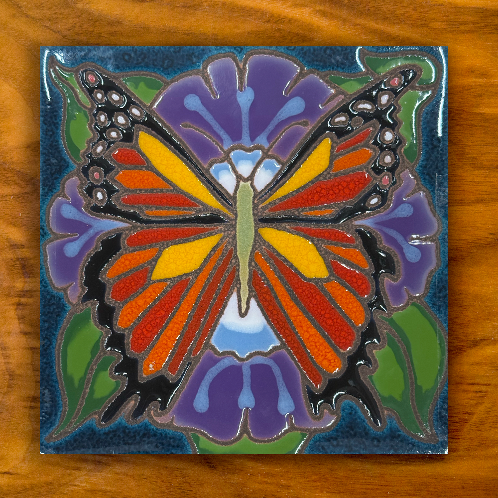 Monarch butterfly ceramic tile on wooden background