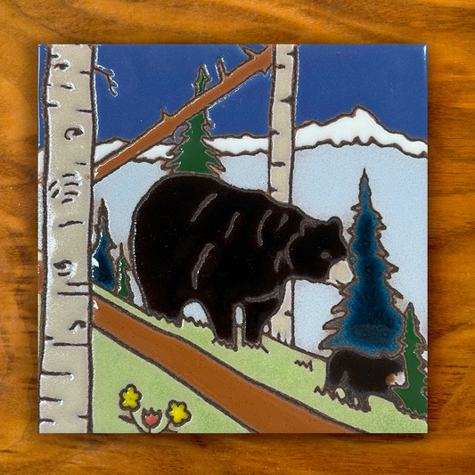 black bear and cub in the forest hand painted ceramic tile on a wooden background