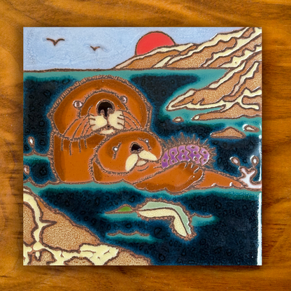 sea otter in the ocean ceramic tile on a wooden background