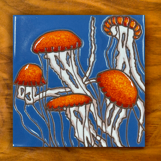 Jellyfish ceramic tile on a wooden background
