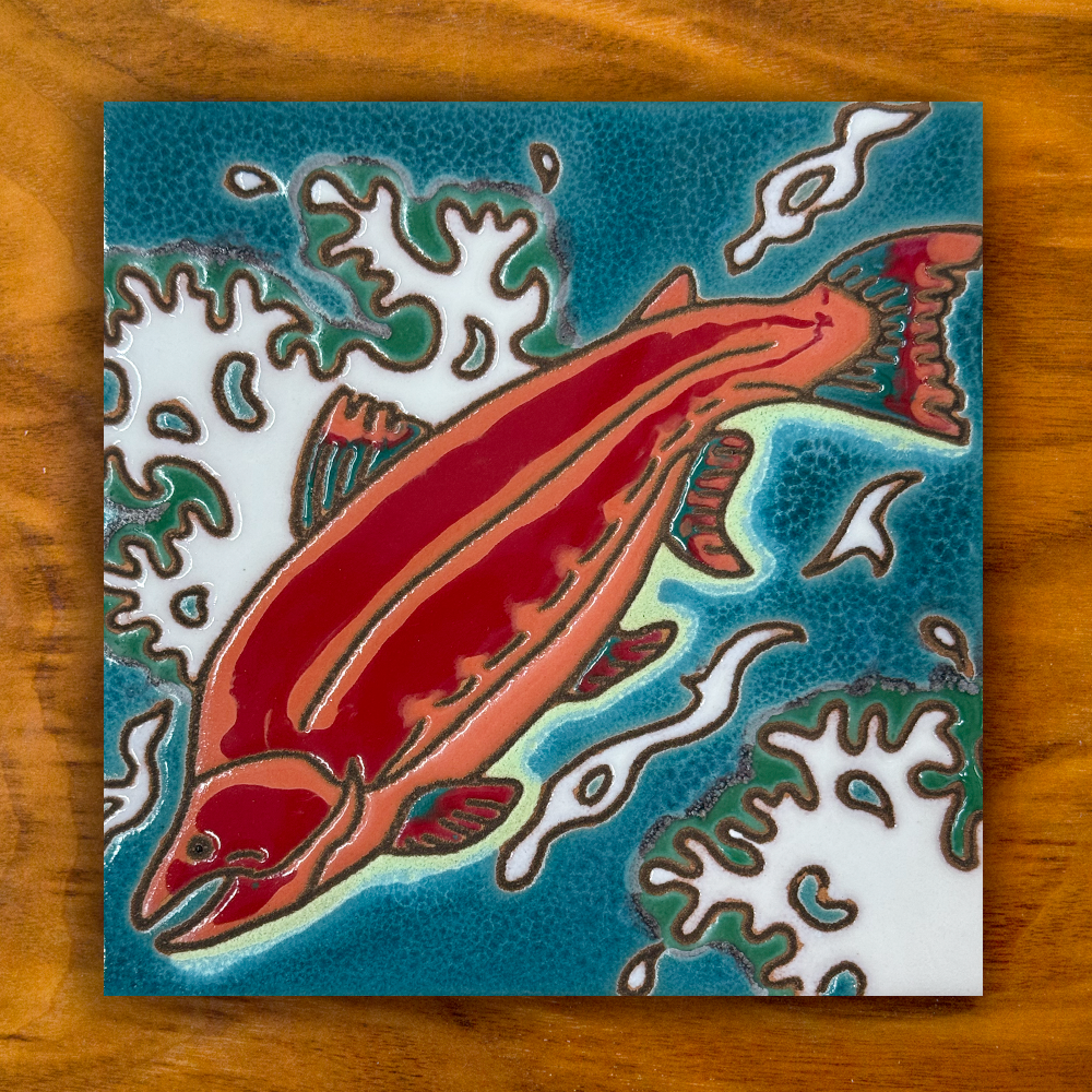 red salmon ceramic tile shown on a wooden table