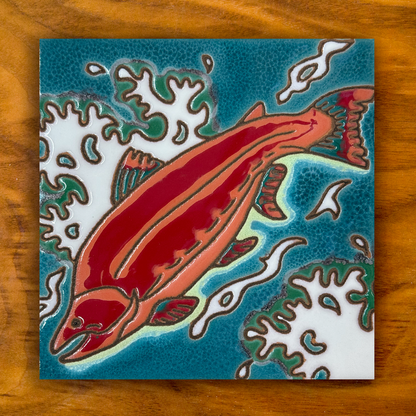 red salmon ceramic tile shown on a wooden table