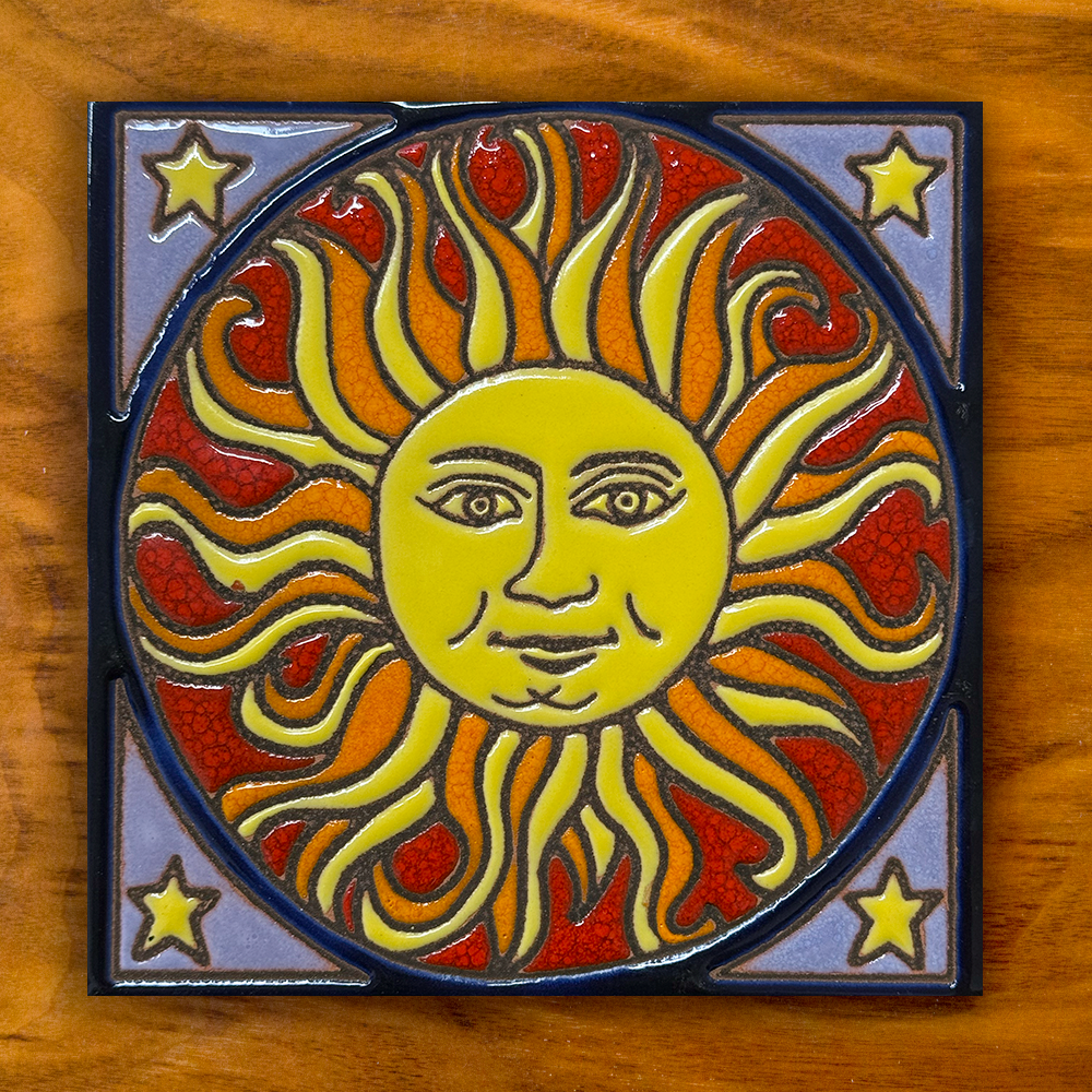 sun ceramic tile on a wooden background