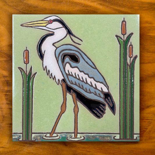 great blue heron green ceramic tile on wooden background