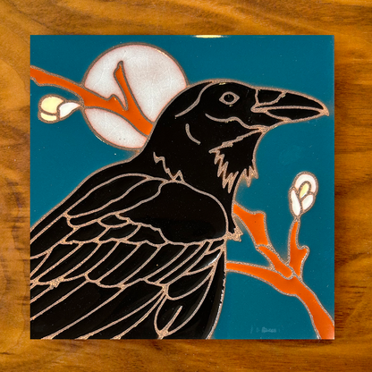 owl ceramic tile coaster on a blue background with wood table