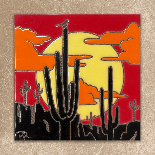 ceramic tile of cacti with a sunset background on a textured surface