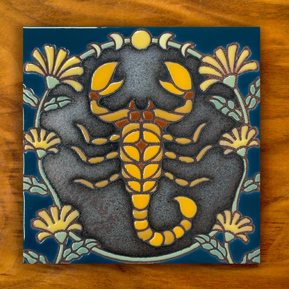 Scorpion with yellow flowers ceramic tile on a wooden background