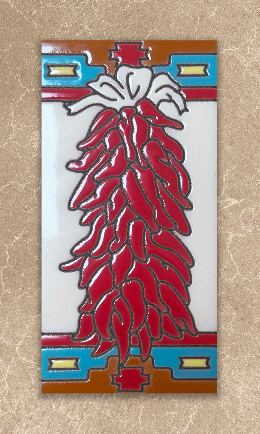 Decorative tile with red chili design on a beige background