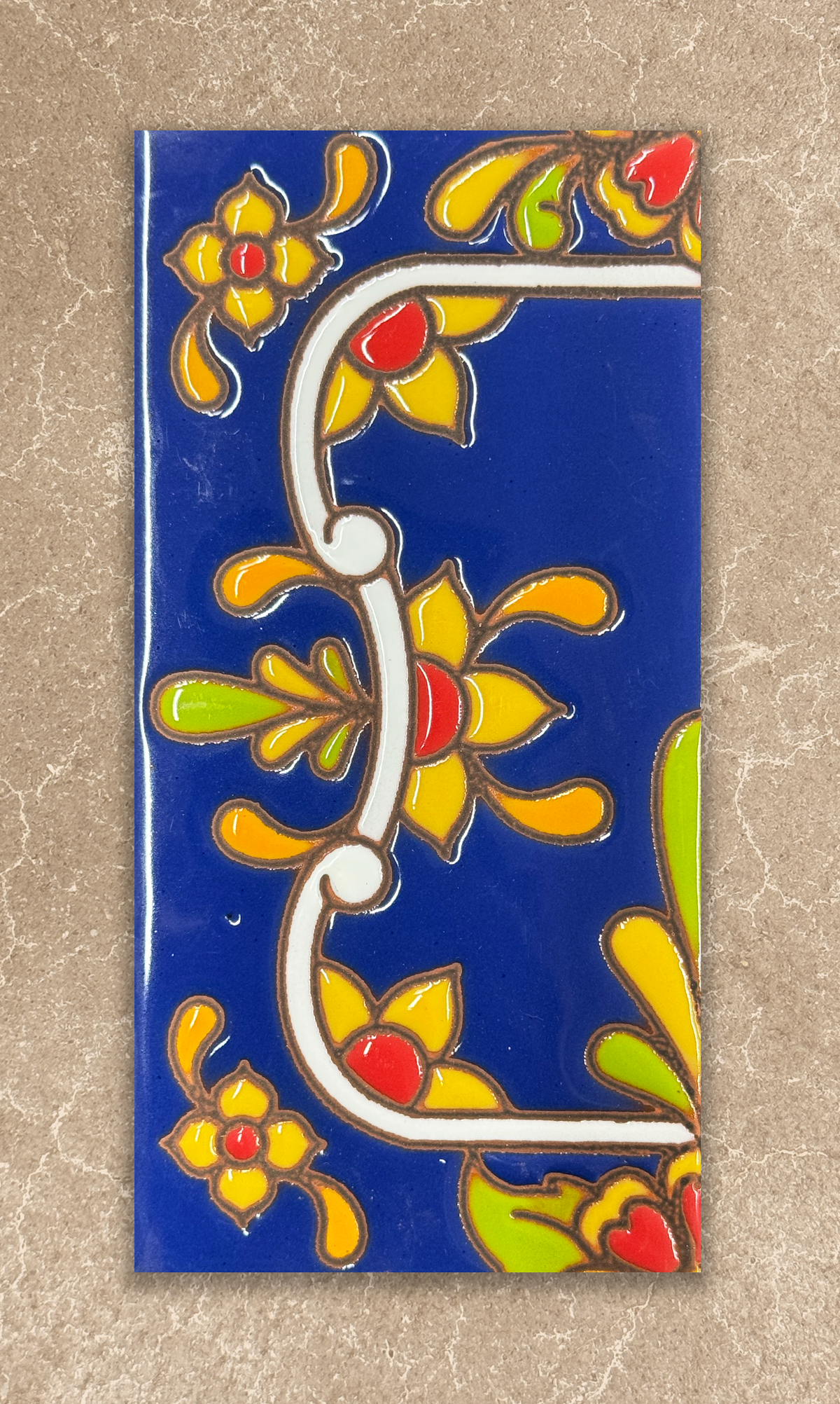 Decorative tile with floral patterns on a blue background
