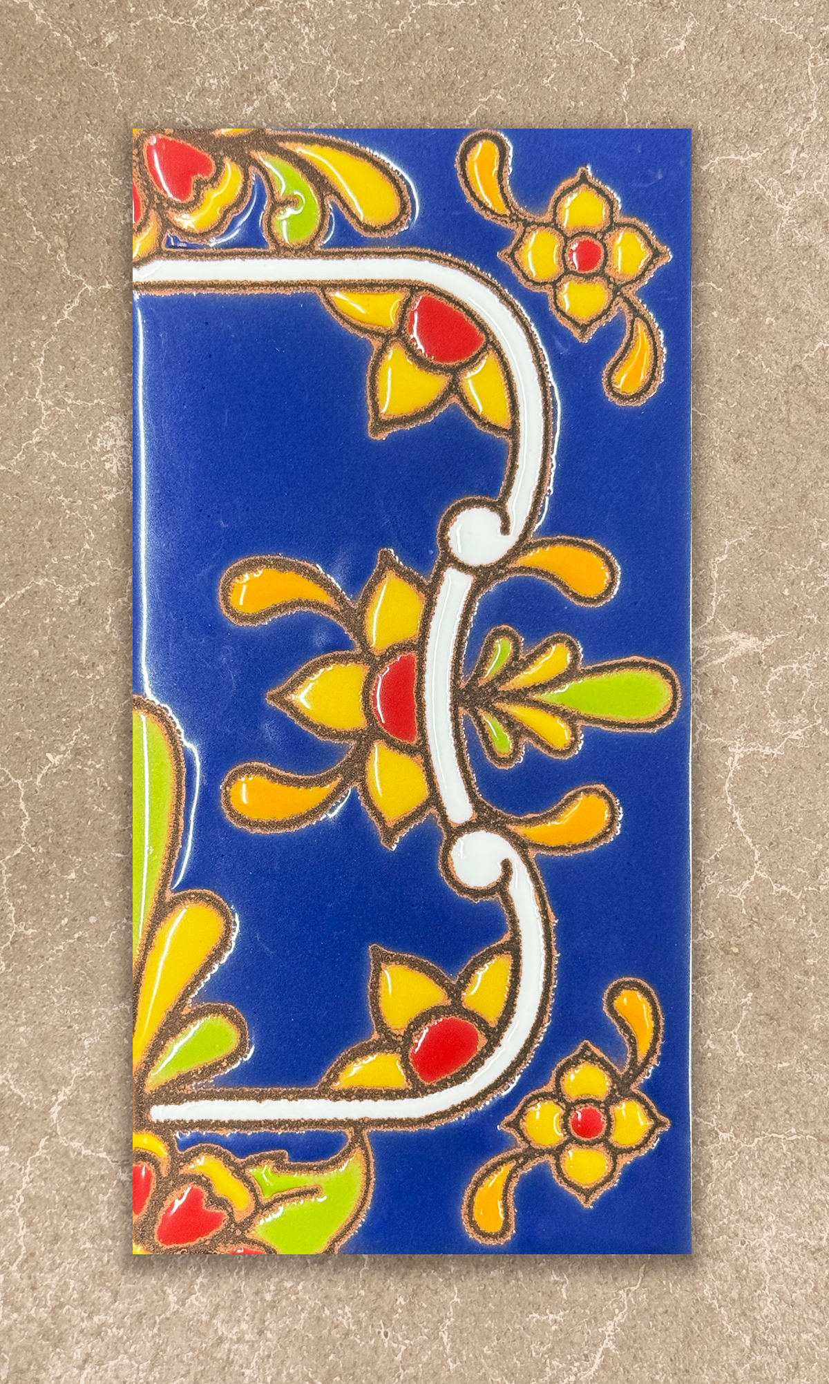 Decorative tile with colorful floral patterns on a blue background