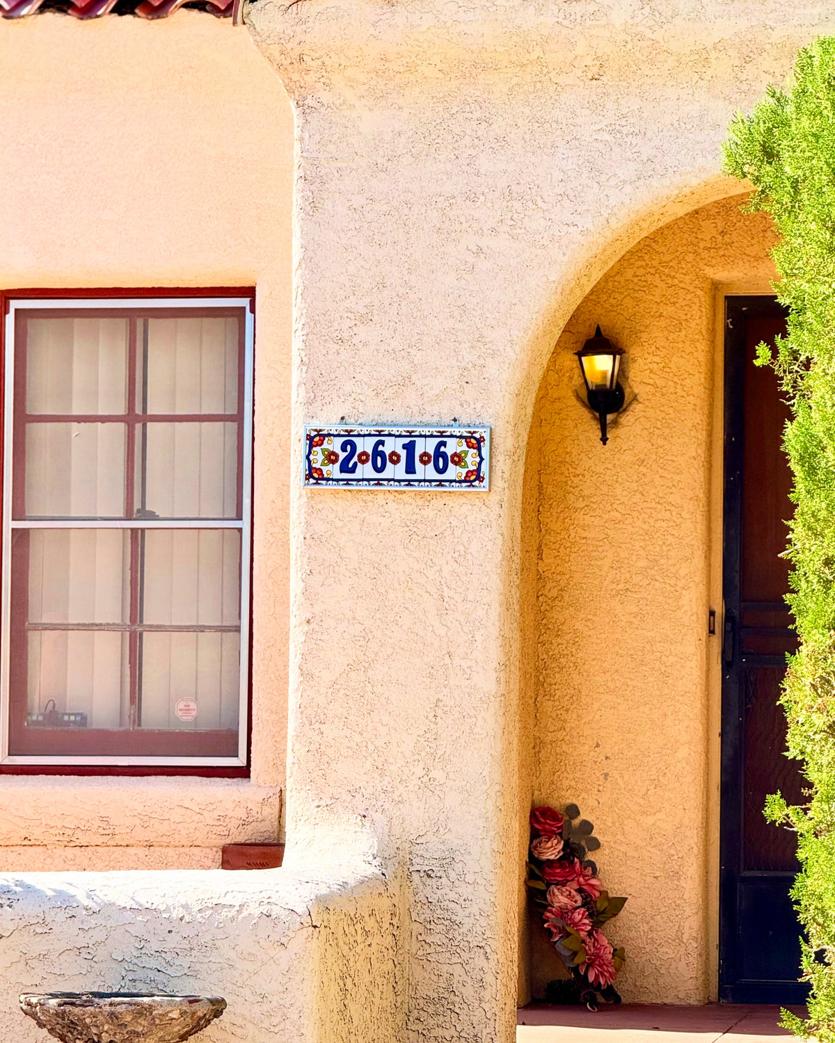 colorful white and blue talavera address sign on house