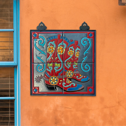 Decorative metal tile with boot design on an orange wall