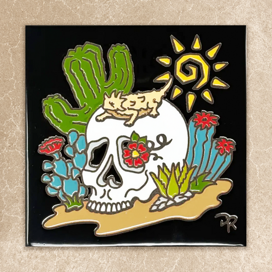 Decorative tile with a skull design, cactus, and sun on a beige background