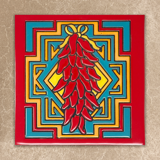Decorative tile with red chili peppers and geometric pattern on a beige background