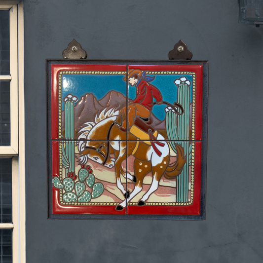 Decorative tile with a cowboy riding a horse on a gray wall