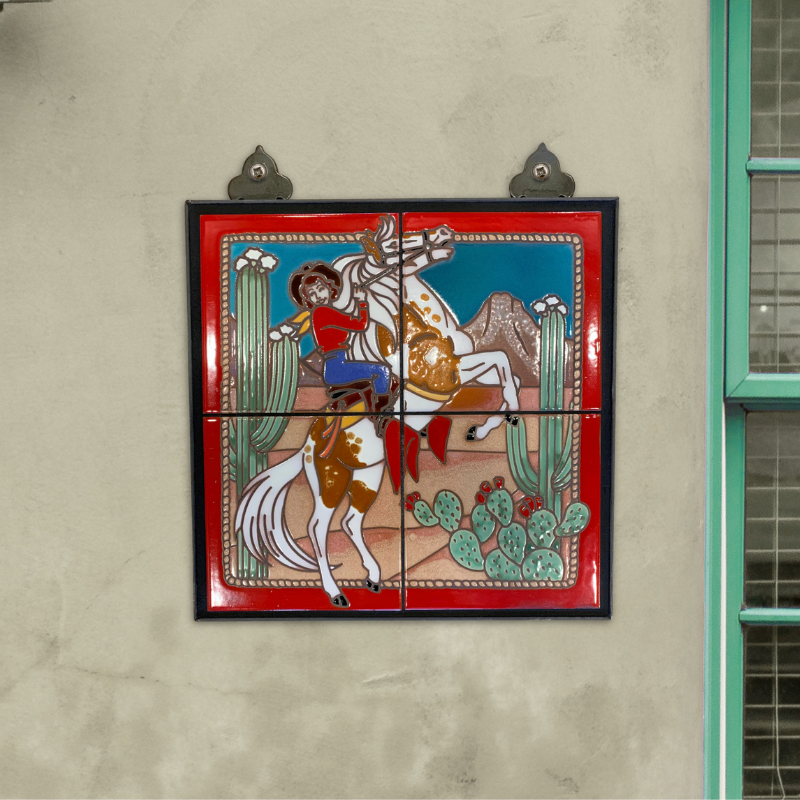 Decorative tile with a cowgirl and horse design on a wall.