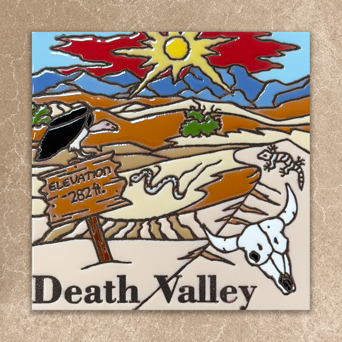 Decorative plaque with a desert scene and 'Death Valley' text on a textured beige background