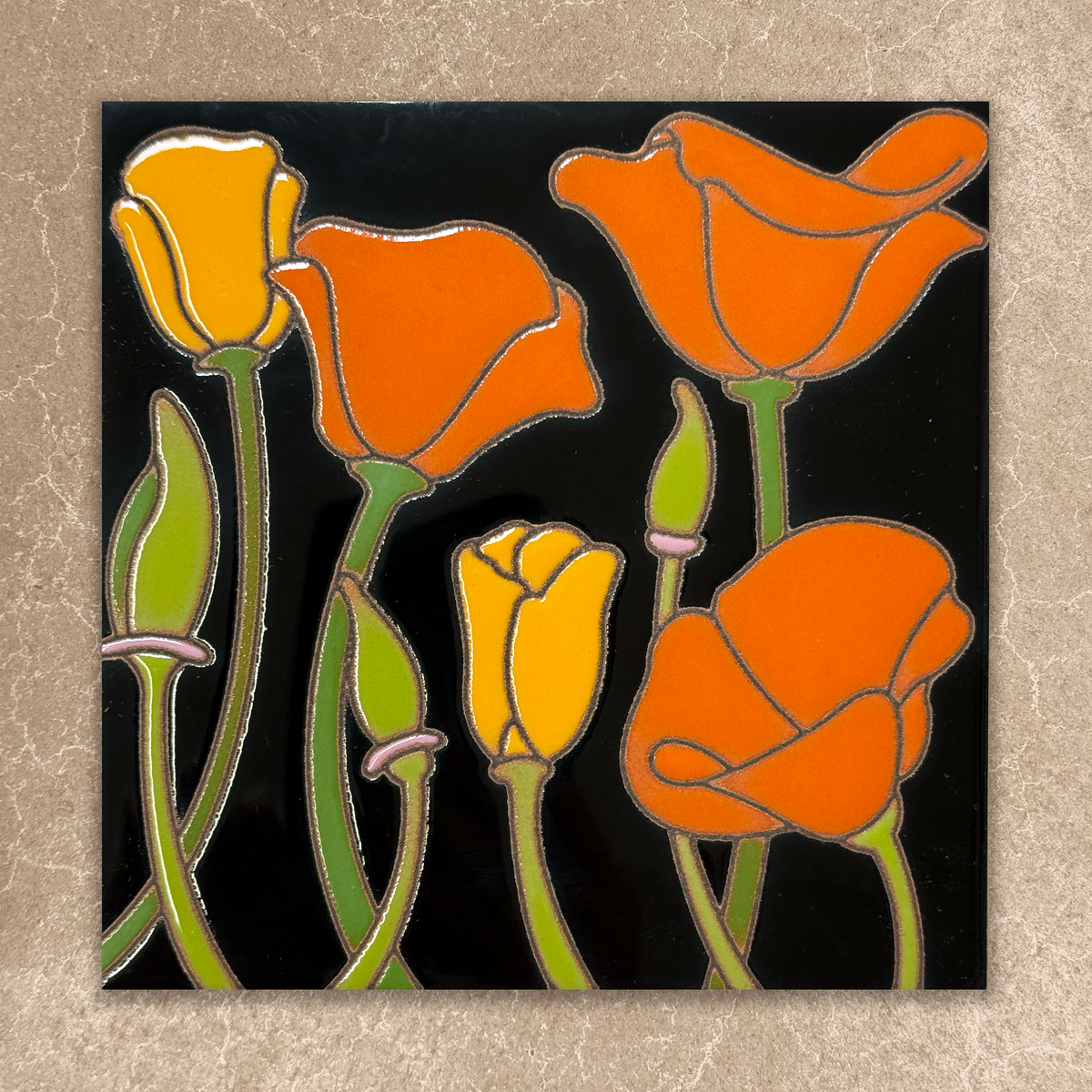 Stylized orange and yellow flowers ceramic tile on a black background
