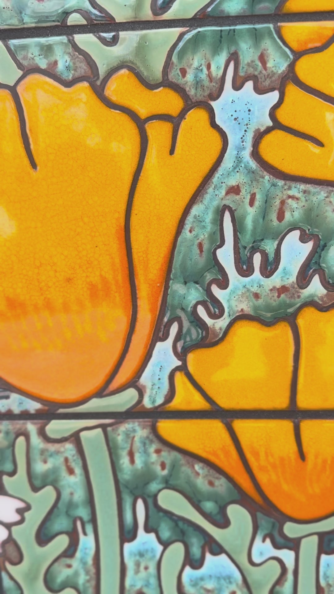 ceramic tile panel wall art with orange poppy flowers and mountains on a textured wall.