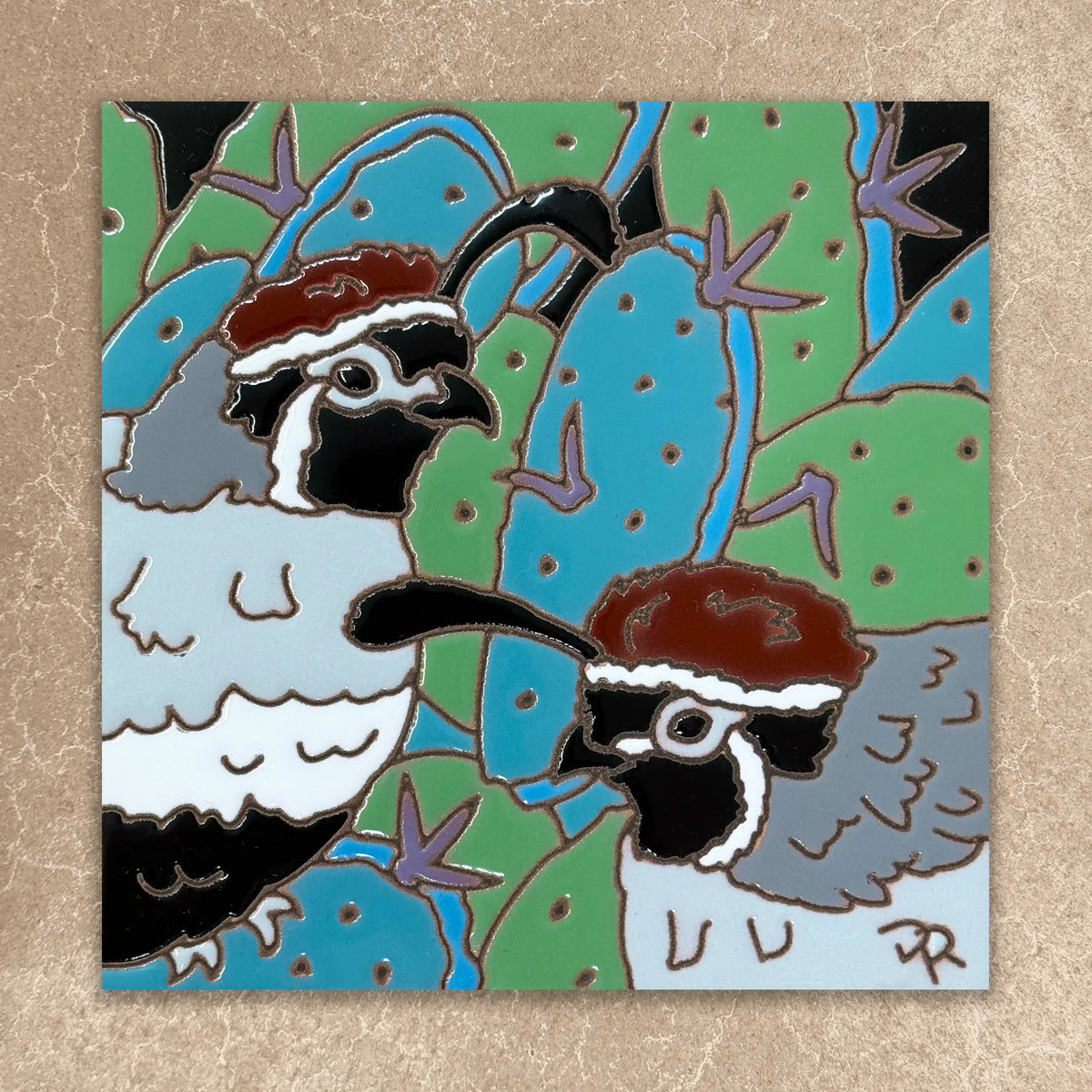 Two quails with cacti on a square tile with a beige border